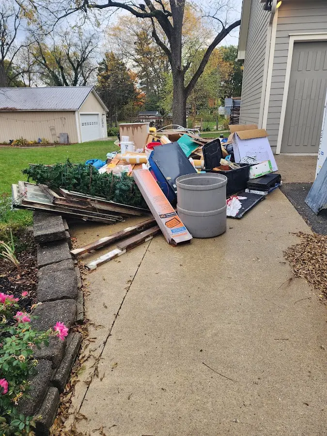 Dumpster being loaded with debris for Roofing Dumpster Rental in Amityville